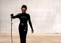 The Queen Obsidian possesses her singletails ominously in her spandex catsuit.