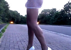 Public road ambling in milky fishnet mini miniskirt .