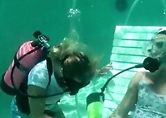 Scuba woman tied in chair underwater