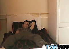 The handsome twink is relaxing on the bed & wanking off