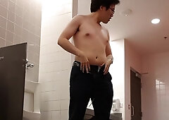 Asian slut strips and jerks his little cock in a public washroom