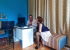 Redheaded office dominatrix humiliates her kneeling employee with foot worship