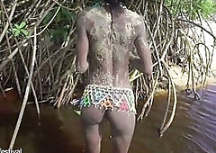 Slender tribe gal with a body full of mud exposed outdoor