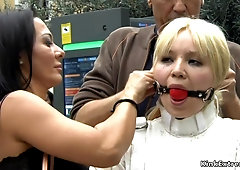 Nude blond in strait jacket in public