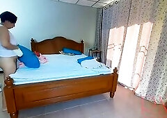 Nudist housekeeper Regina Noir makes the bedding in the bedroom. Exposed maid. Undressed housewife. 1