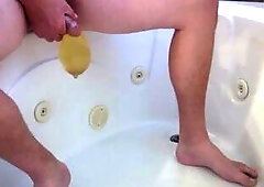 Pissing into a cock rubber in the bathtub