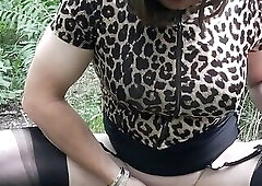 Mature crossdresser Holly pissing in the woods