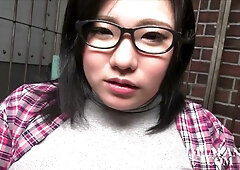 Voluptuous Japanese woman with huge tits explores pleasure in a brick-walled room