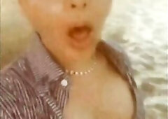 Oriental cute ladyboy masturbating and cumming on a public beach