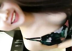 Pleasing Vietnamese chick is often posing in front of the camera and showing her cleavage