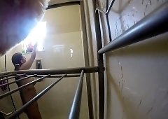 Voyeur spying on a pretty amateur brunette taking a shower