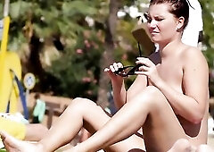 All- natural, German brunette hair with large breasts doesn't mind being topless on a local beach