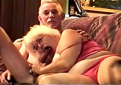 Grandma sucks grandpa's cock, while he watches tv.