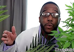 Muscular and oiled hunk masturbated by a black doctor in the infirmary