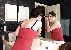 Shapely cougar slides off her red evening gown and pleasures her snatch