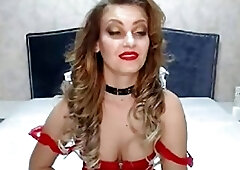 Glamorous shemale in a red corset masturbates in her bedroom
