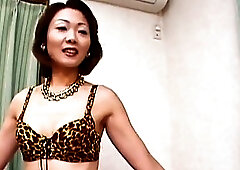 Classy Asian MILF in fishnet stockings plays with her hairy pussy