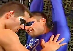 Spandex superhero lads snared in bondage and told to fuck each other