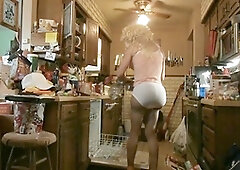 Shemale has kitchen fun in stockings and panties