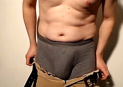 Close up of man undressing and pleasuring his uncut cock until fully erect