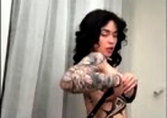 Tattooed butt arches as that babe holds the whip ?