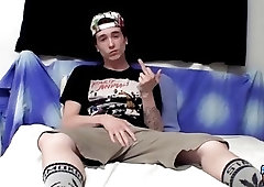 Naughty twink teases the camera while tugging on his boner