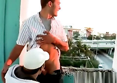 Gay couple making love at a balcony