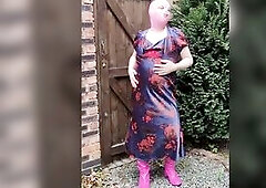 Masked crossdresser floozy parading in the garden full length satin suit