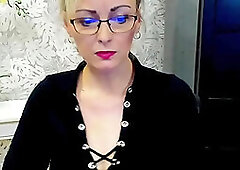 Blonde amateur German MILF LUXvanessa in mini skirt and black blouse with big cleavage flashing boobs on solo webcam show