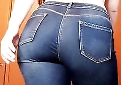 Large corpulent flawless booty walking in blue jeans and showing it off