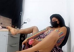 Yummy babe in a mini-skirt and fishnet stockings takes a huge dildo