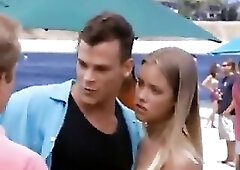 Kristanna Loken hawt showing us her cleavage whilst hanging out in her little bikinis and then we watch her giving a kiss with some dude on the beach.