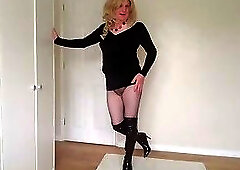 Little black dress with fishnets and latex boots