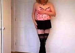 Pink top, black miniskirt and hold up stockings