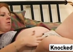 Redhead pleasures her preggo twat with a toy