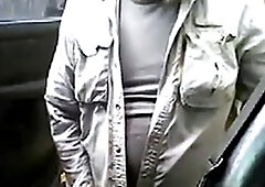 Bearded daddy strokes his cock by his truck outdoors.