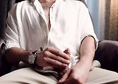 Close-up view of teen NoelDero with condom getting jerked off and milked