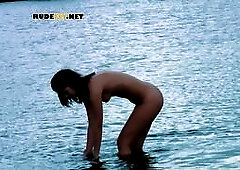 Cute nude beach girl caught on a hidden camera having fun with her friend