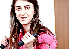 Butterface strips in home gym after a workout and fingers herself