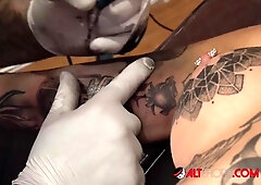 Amber Luke rubs her swollen clit and cums while the needle tattoos her smooth skin