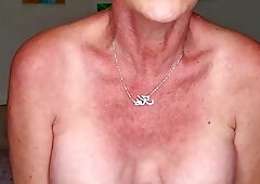 Mature tattooed blonde Kiki shows off her ass and pussy
