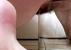 Hotty with Bushy Snatch Peeing into Glass Jar from Behind