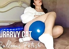 A curvaceous beauty plays with a balloon and shows beautiful legs in white socks