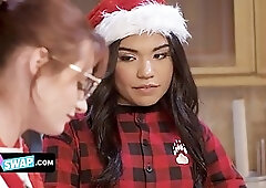 Slutty girls are having a foursome in front of a Christmas tree and enjoying it