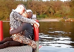 Loving boyfriends share a passionate kiss on a pier