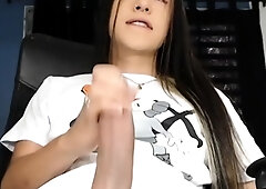 Young Tranny Shows Off Her Big Cock in an Explosive StripTan