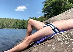 Canadian dude sunbathes in his swim trunks before bare snorkelling!