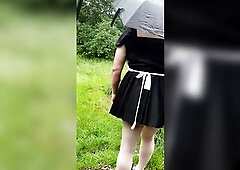 Crossdressing wench Maid rides dildos on public picnic bench in the daytime on a rainy day