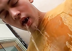 Naughty twink pissing all over his shirt while jerking off