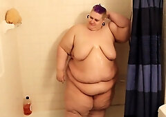 Plump purple-haired BBW sensually lathers up in a steamy shower